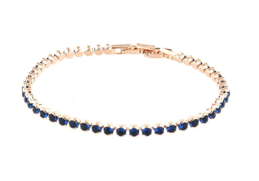 Tennis bracelet in pink metal with blue crystals