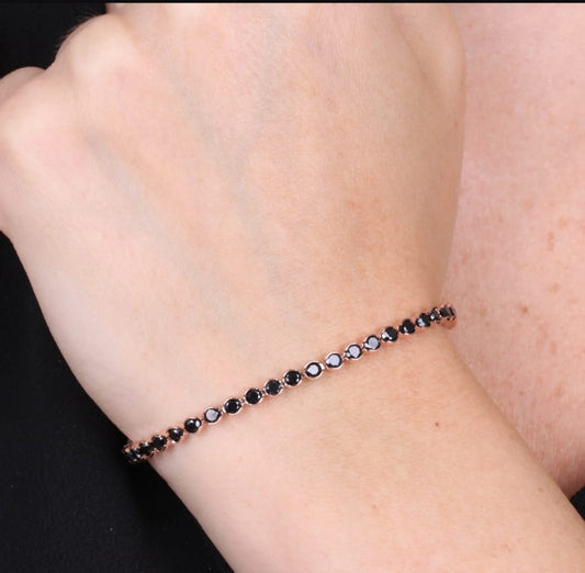 Tennis bracelet in pink metal with black crystals
